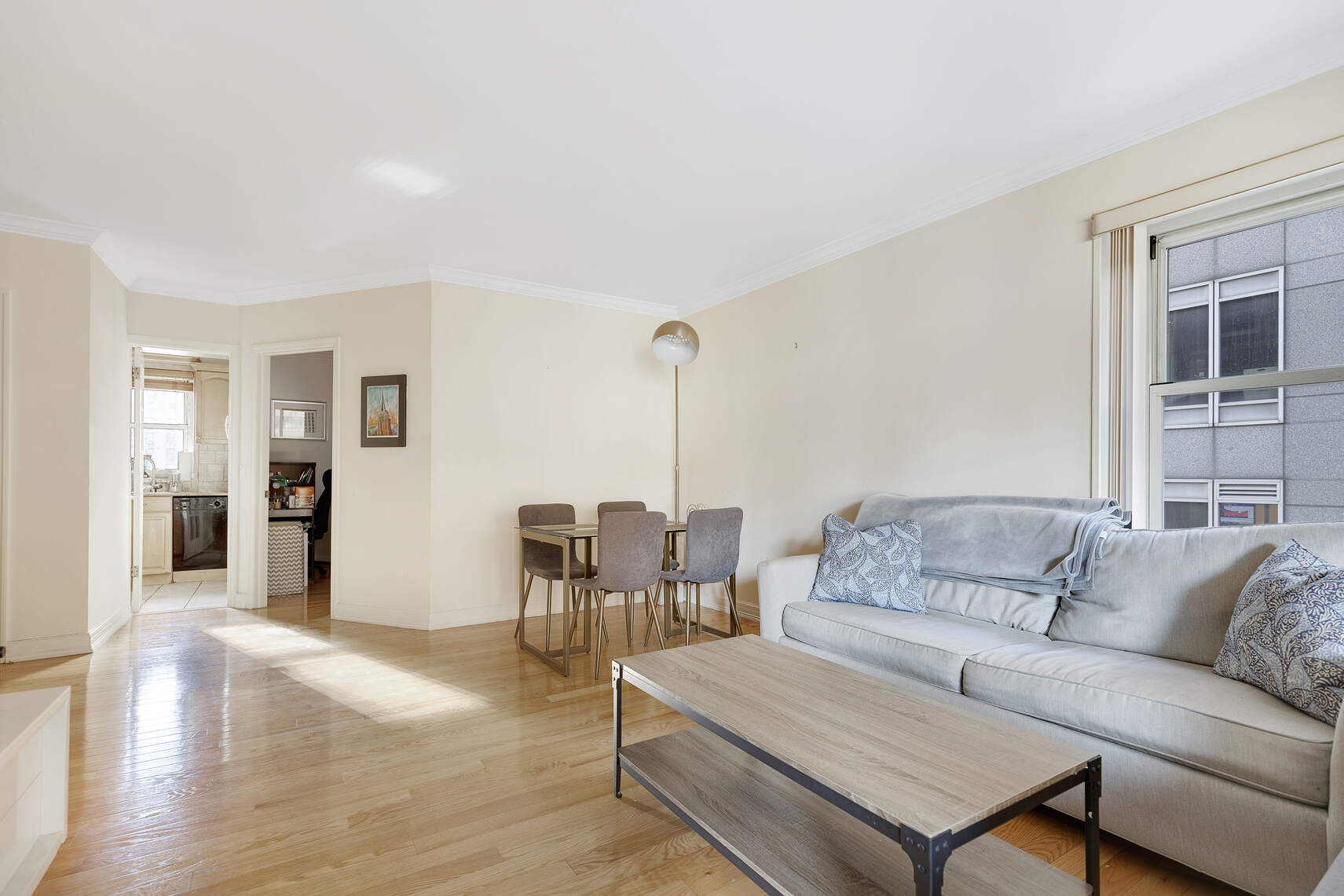 159 West 53rd Street, Unit 18B Manhattan, NY 10019 - Photo 3 of 11 a living room with furniture and wooden floor