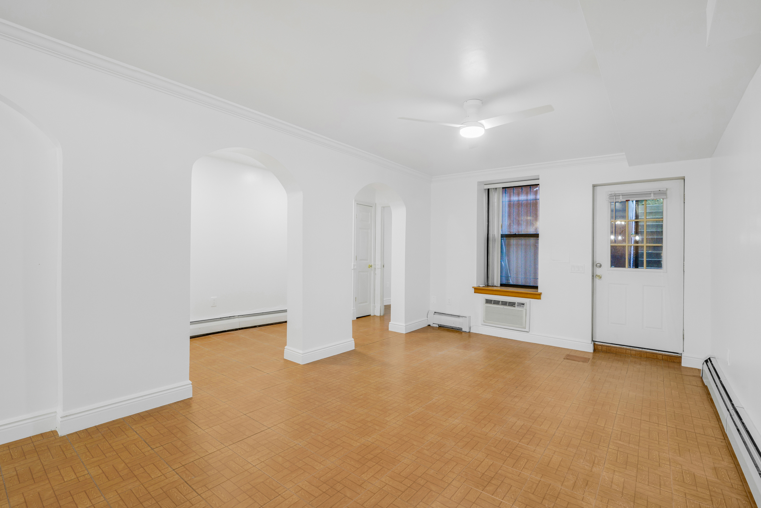 3 East 128th Street, Unit GARDEN Manhattan, NY 10035 - Photo 5 of 10 wooden floor in an empty room with a window