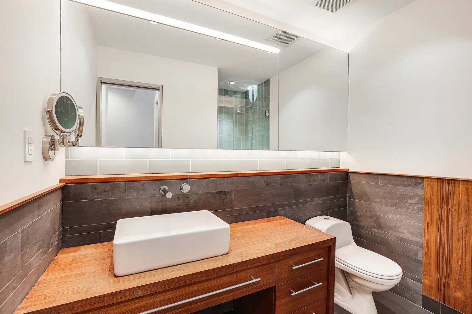 a bathroom with a sink a toilet and a mirror