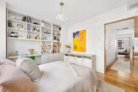 a bedroom with a bed and a cabinets