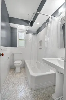 a bathroom with a sink toilet tub and shower