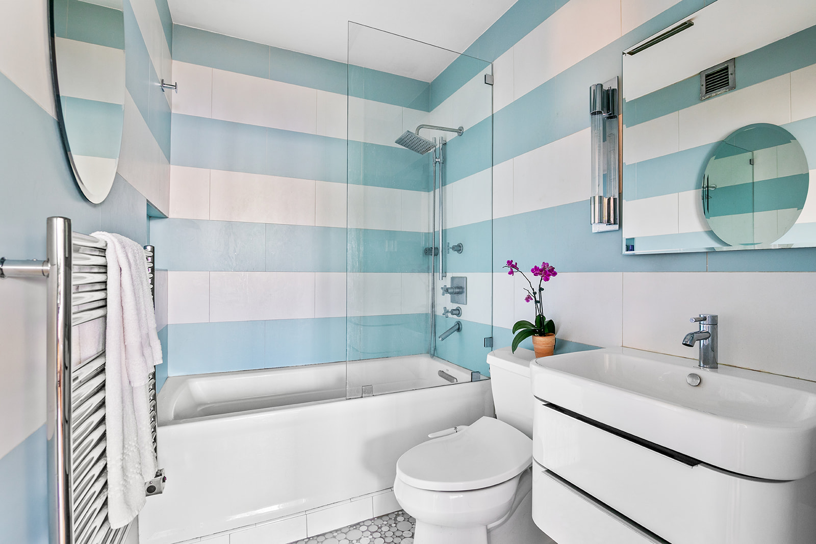 167 Perry Street, Unit 5N Manhattan, NY 10014 - Photo 9 of 12 a bathroom with a sink toilet and shower