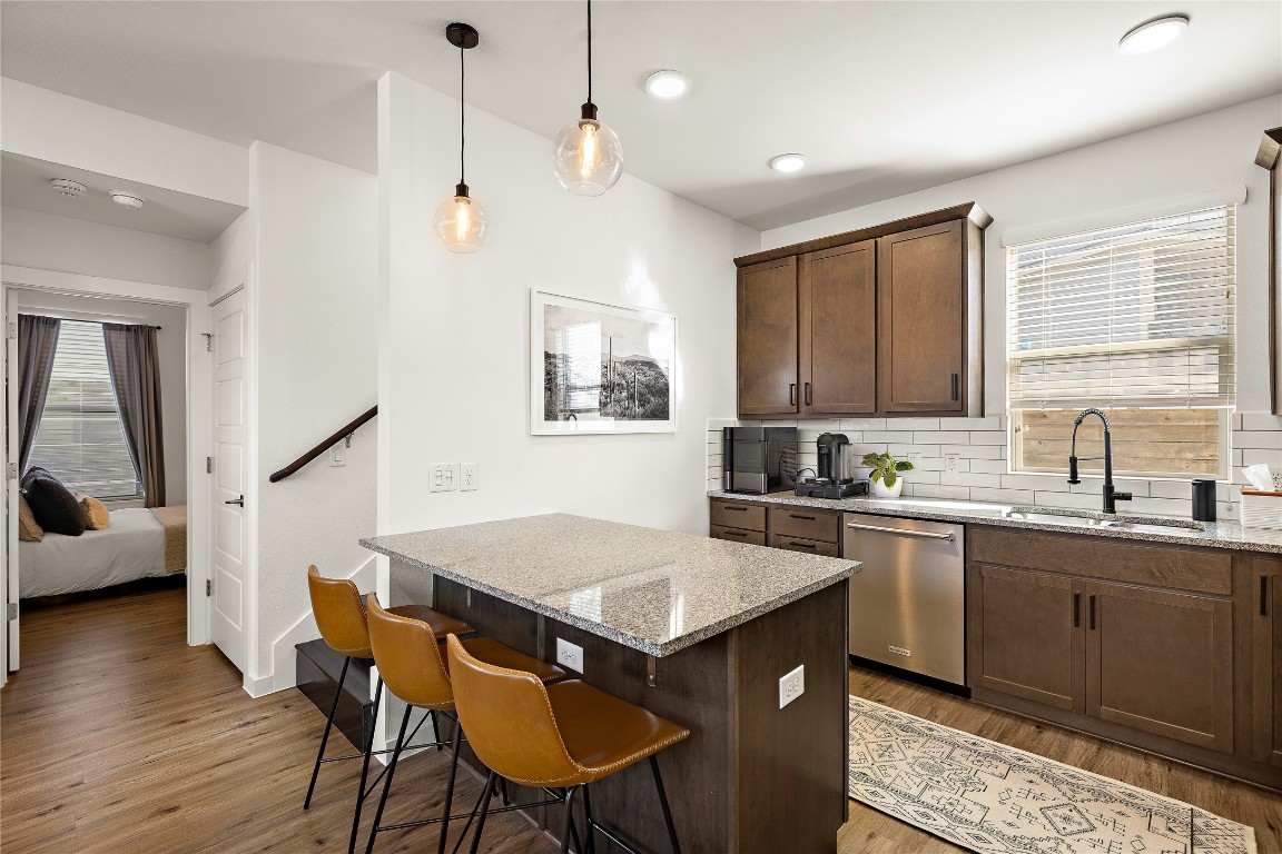 1402 Singleton Avenue, Unit B Austin, TX 78702 - Photo 5 of 26 a kitchen with a stove a sink a dining table and chairs