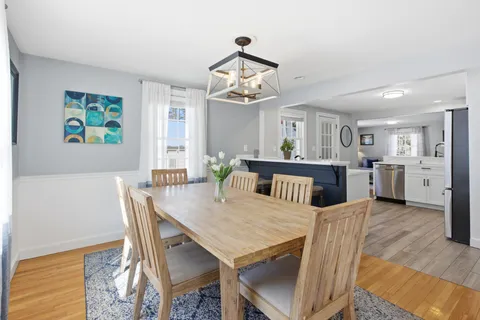 a view of a dining room with furniture and chandelier