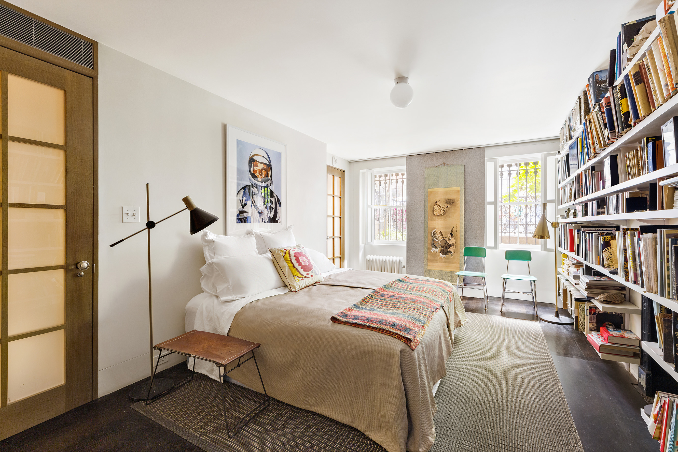 25 Perry Street Manhattan, NY 10014 - Photo 29 of 32 a bedroom with a bed and a book shelf