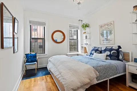 a bedroom with bed and a window