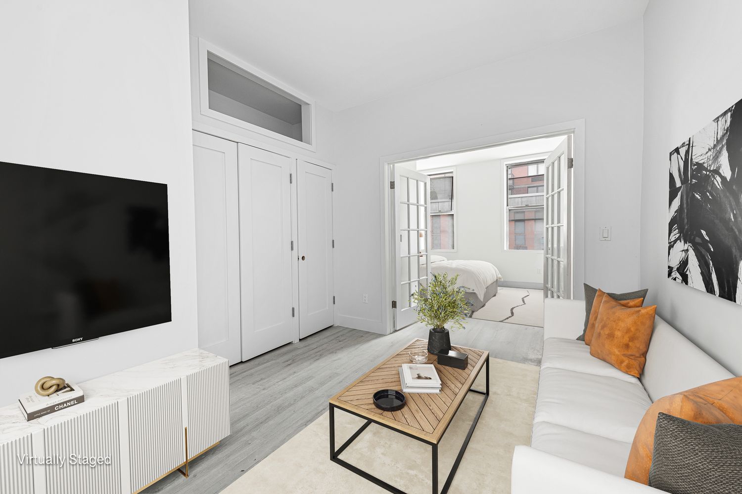 25 East 7th Street, Unit 9 Manhattan, NY 10003 - Photo 1 of 5 a living room with furniture and a flat screen tv