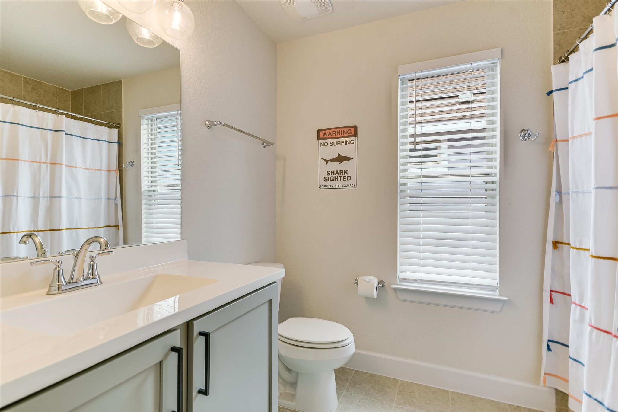 8607 McKamy Drive Austin, TX 78744 - Photo 18 of 28 a bathroom with a sink a toilet and a window