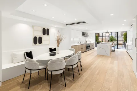 a dining room with furniture and wooden floor