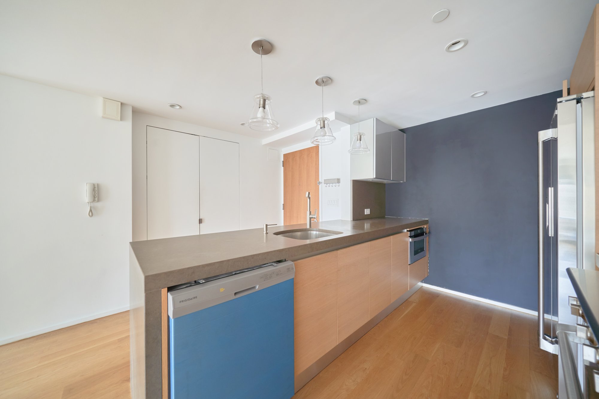 2280 Frederick Douglass Boulevard, Unit 5D Manhattan, NY 10027 - Photo 2 of 22 a kitchen with granite countertop a sink and a refrigerator