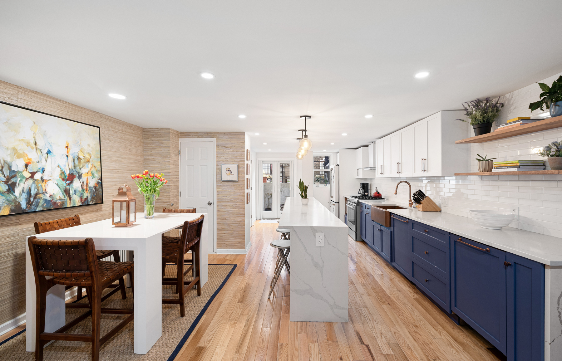 202 22nd Street Brooklyn, NY 11232 - Photo 6 of 28 a view of a kitchen with kitchen island stainless steel appliances a dining table and chairs