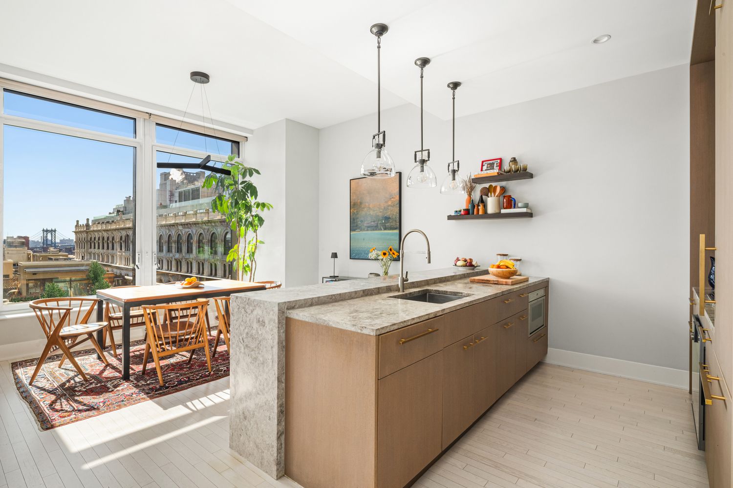 a view of a kitchen with kitchen island stainless steel appliances a sink a counter top space and a window