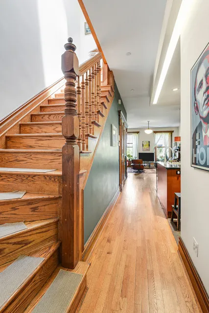 a view of entryway and hall with wooden floor