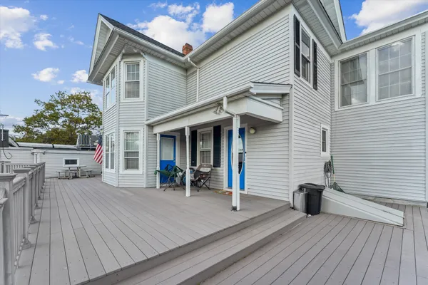 a view of a house with a patio and wooden flooring