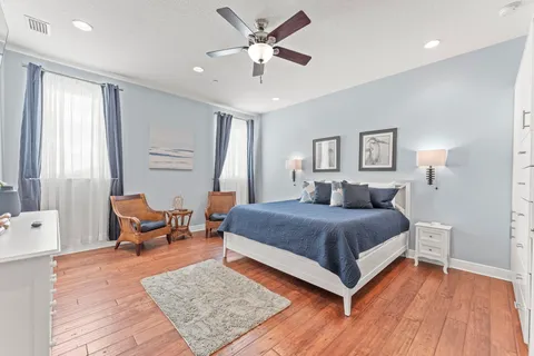 a bedroom with a bed a couch and a window