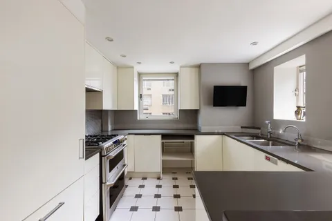 a kitchen with a sink a stove a microwave and cabinets