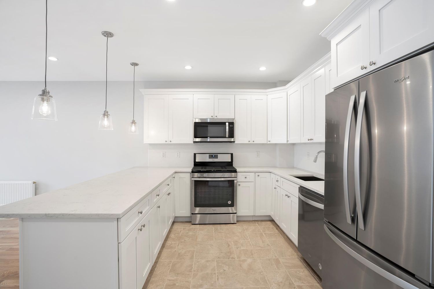 136 Union Street, Unit 2 Brooklyn, NY 11231 - Photo 3 of 9 a kitchen with white cabinets and stainless steel appliances