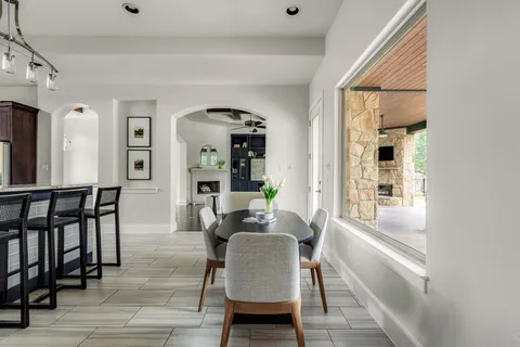 a bathroom with a granite countertop sink a mirror and shower