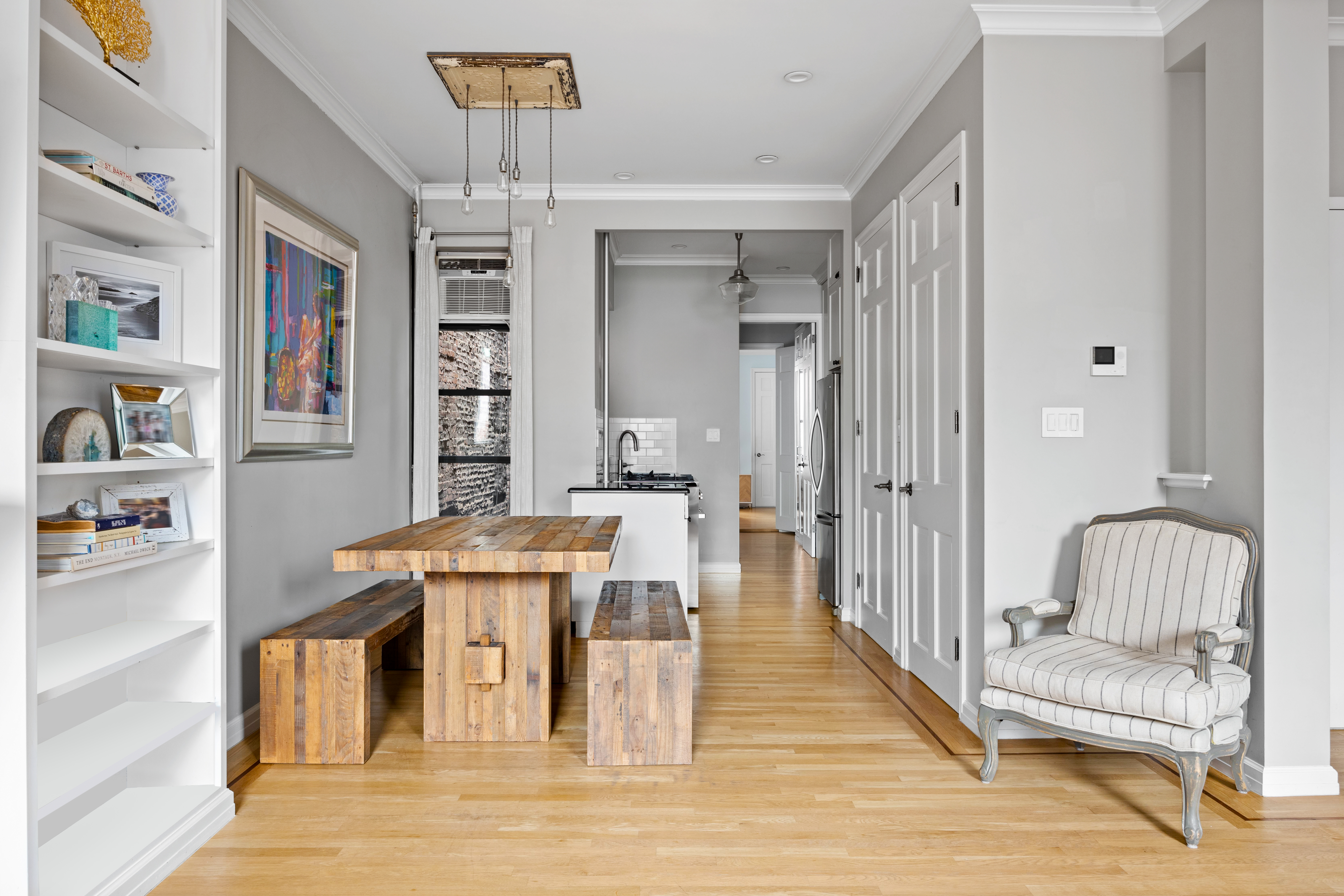 791 Greenwich Street, Unit 6 Manhattan, NY 10014 - Photo 3 of 7 a view of a living room and kitchen with furniture and wooden floor