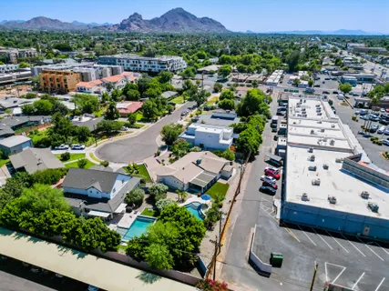 an aerial view of multiple houses with yard