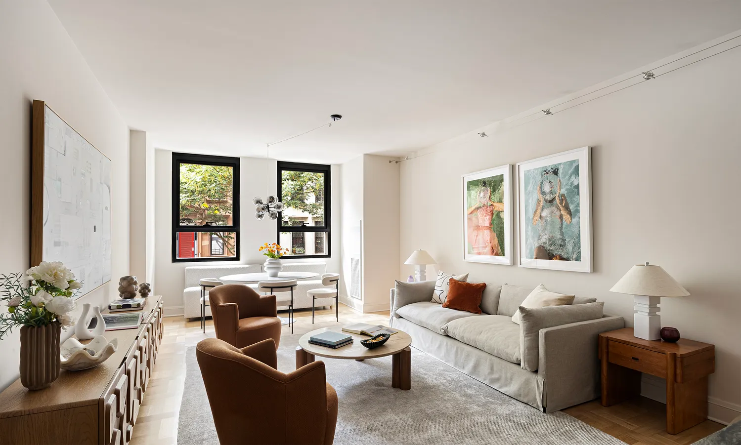 a living room with furniture and large windows