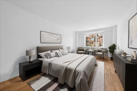a spacious bedroom with a bed a couch and a window
