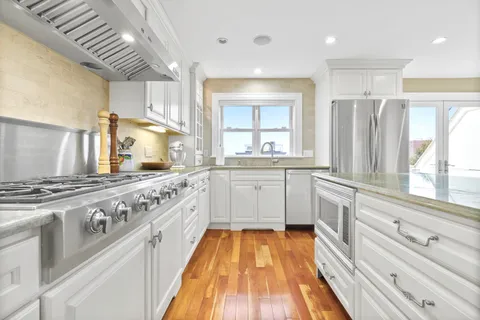a large kitchen with a stove top oven