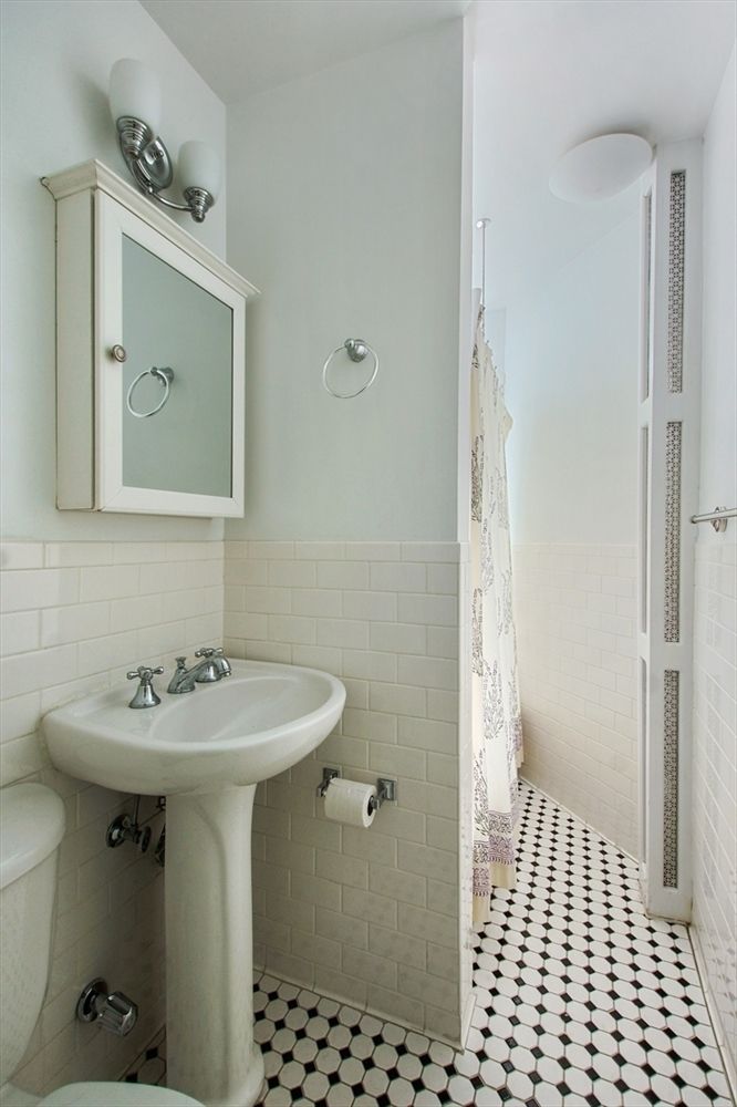 779 Riverside Drive, Unit A50 Manhattan, NY 10032 - Photo 7 of 14 a bathroom with a sink a toilet and shower