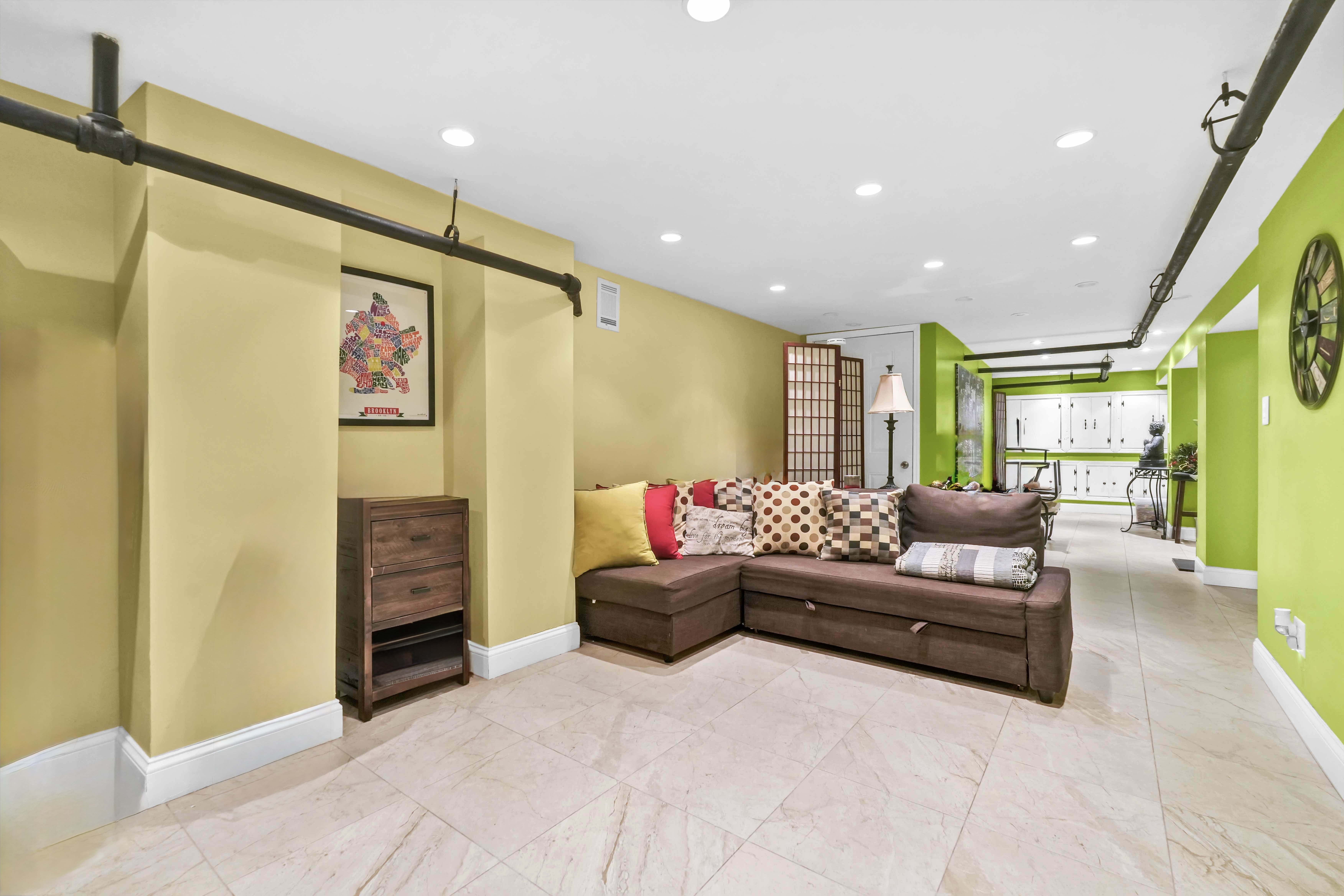 519 Monroe Street Brooklyn, NY 11221 - Photo 51 of 55 a living room with furniture and a flat screen tv