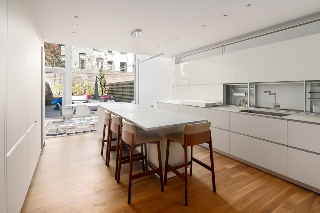 125 West 87th Street Manhattan, NY 10024 - Photo 8 of 27 a kitchen with a table chairs stove and cabinets