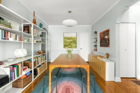a living room with fish tank and a book shelf