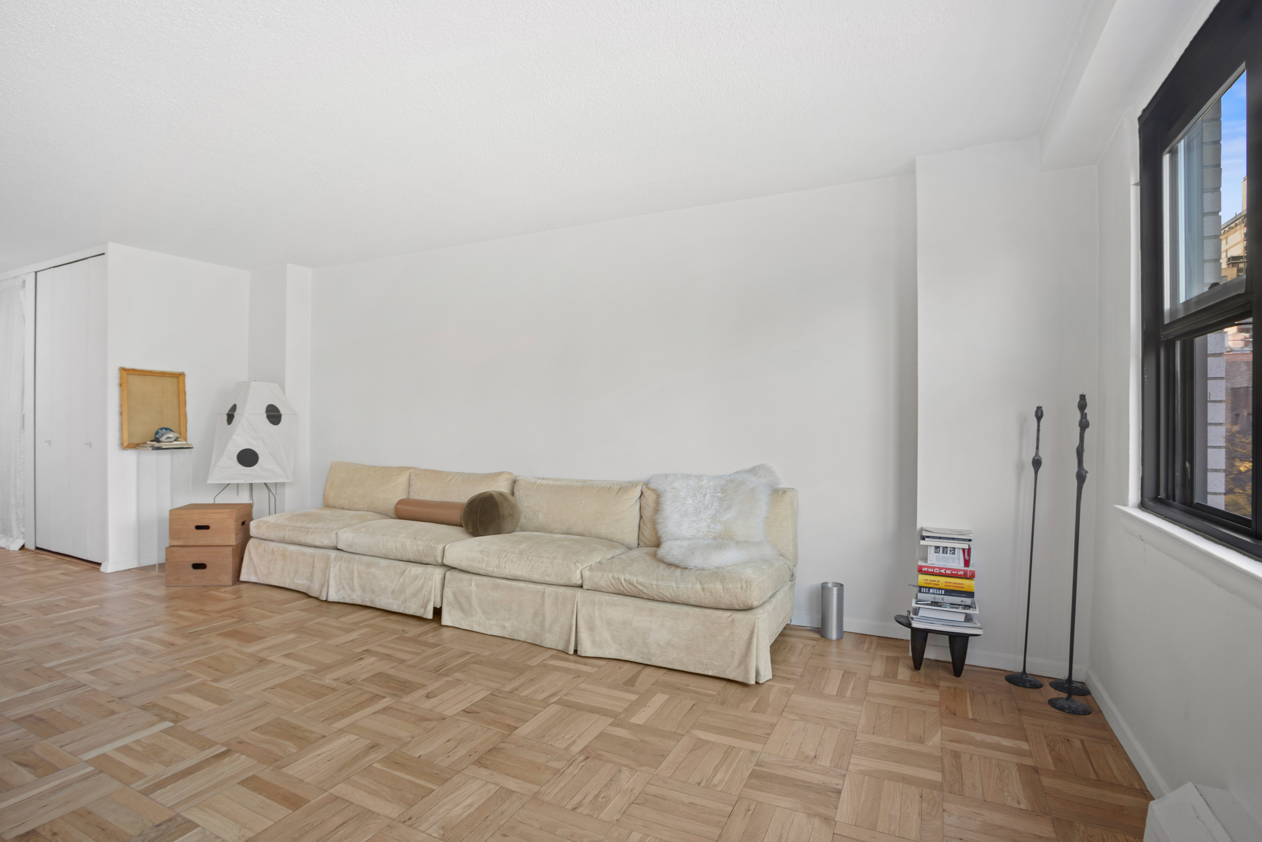 230 East 15th Street, Unit 6C Manhattan, NY 10003 - Photo 3 of 9 a living room with furniture and a book shelf