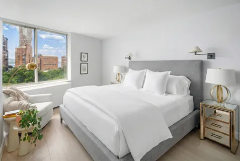 a bedroom with bed and window