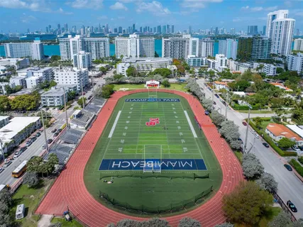 an aerial view of residential house with outdoor space and swimming pool