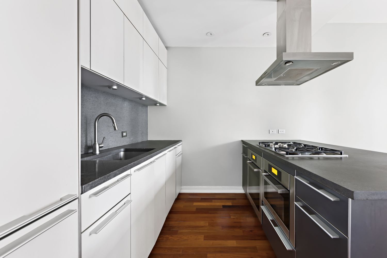 101 Warren Street, Unit 11L Manhattan, NY 10007 - Photo 4 of 26 a kitchen with granite countertop a sink stove and cabinets