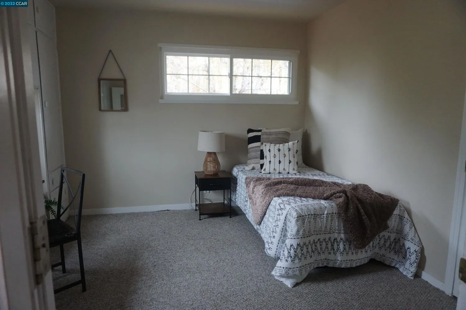 a bedroom with a bed and a window