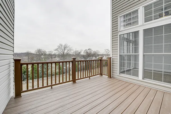 a view of a balcony with wooden floor