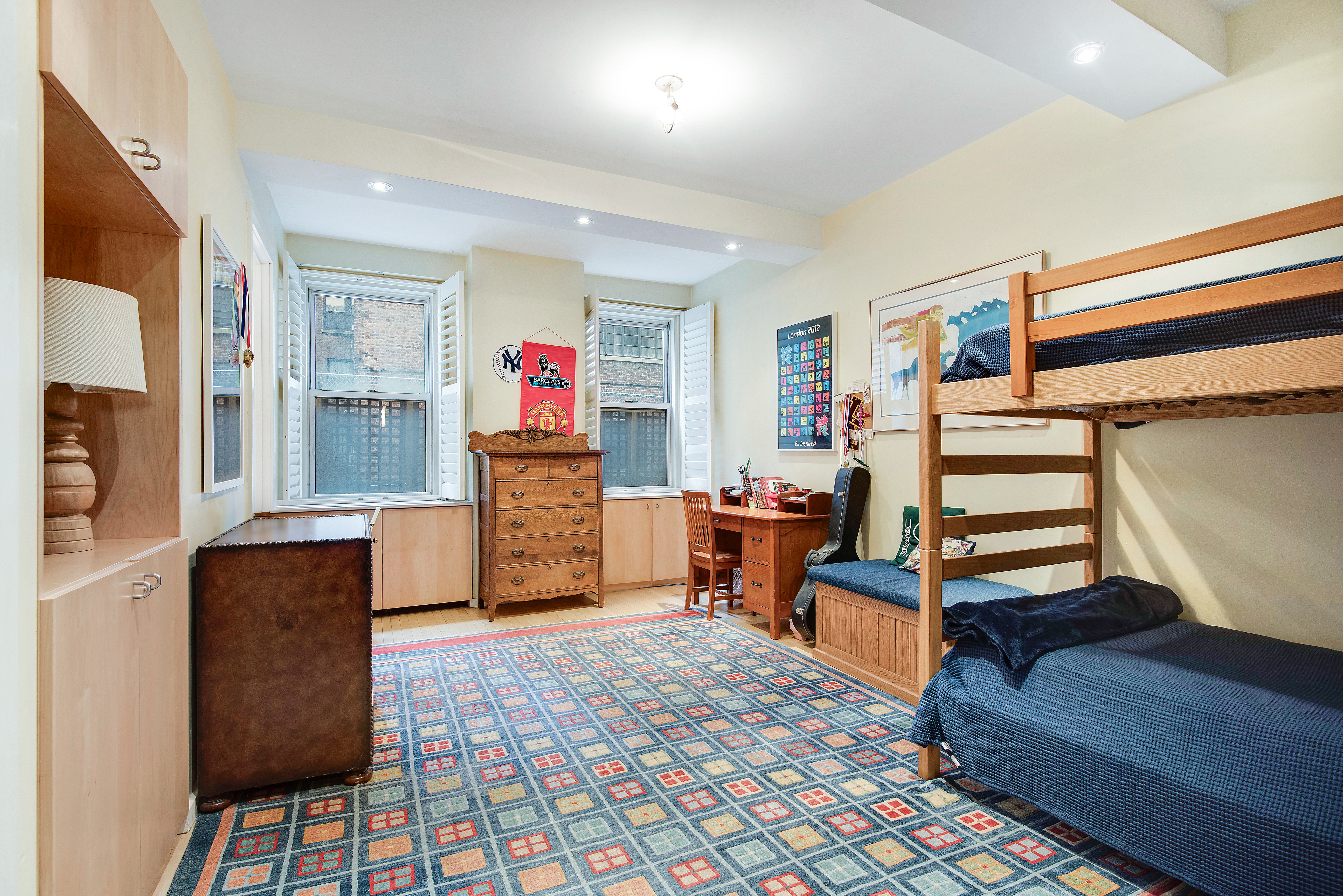 434 East 52nd Street, Unit 1BH Manhattan, NY 10022 - Photo 10 of 23 a living room with furniture and a flat screen tv