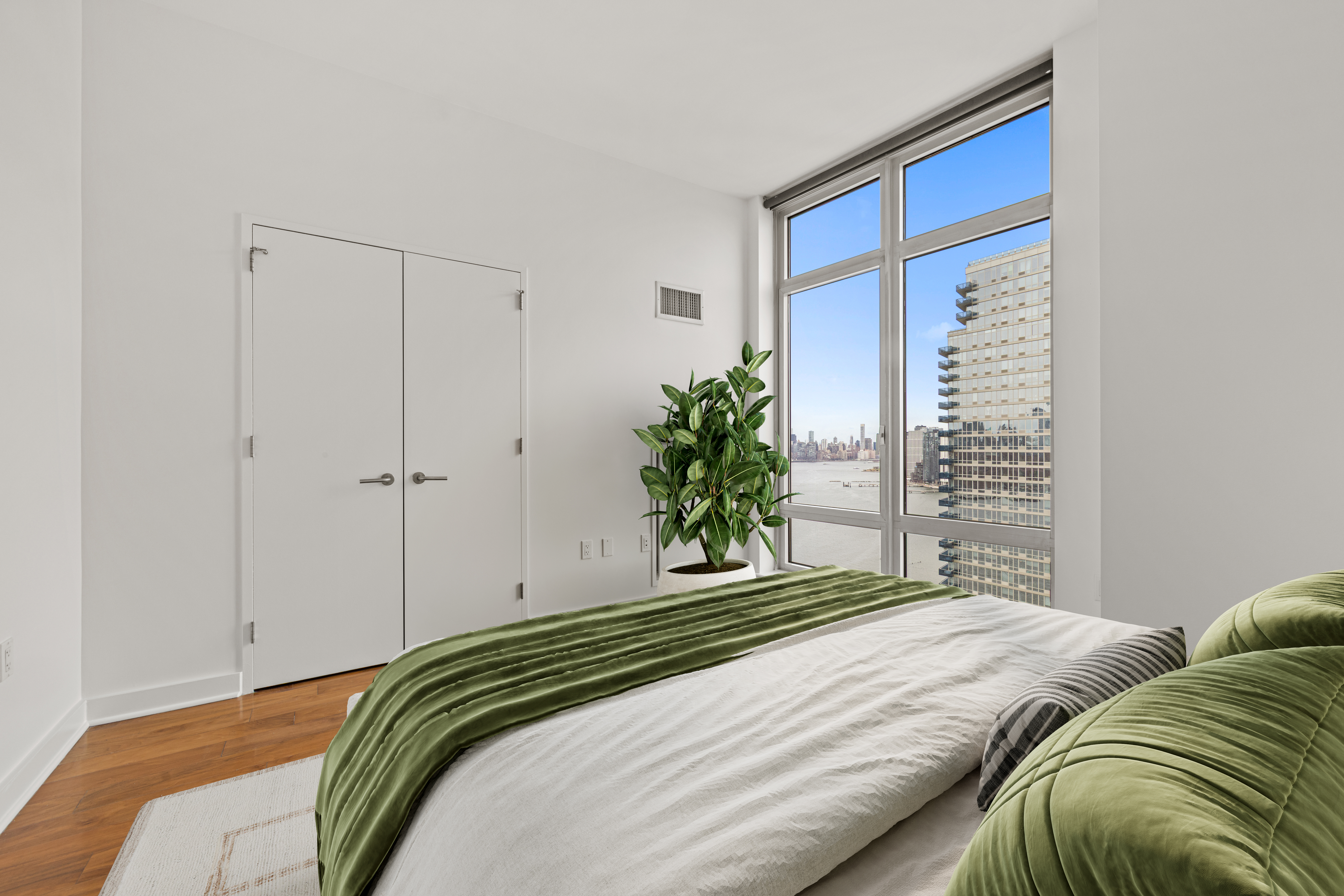 2 Northside Piers, Unit 30Y Brooklyn, NY 11249 - Photo 7 of 22 a bedroom with a bed and a large window
