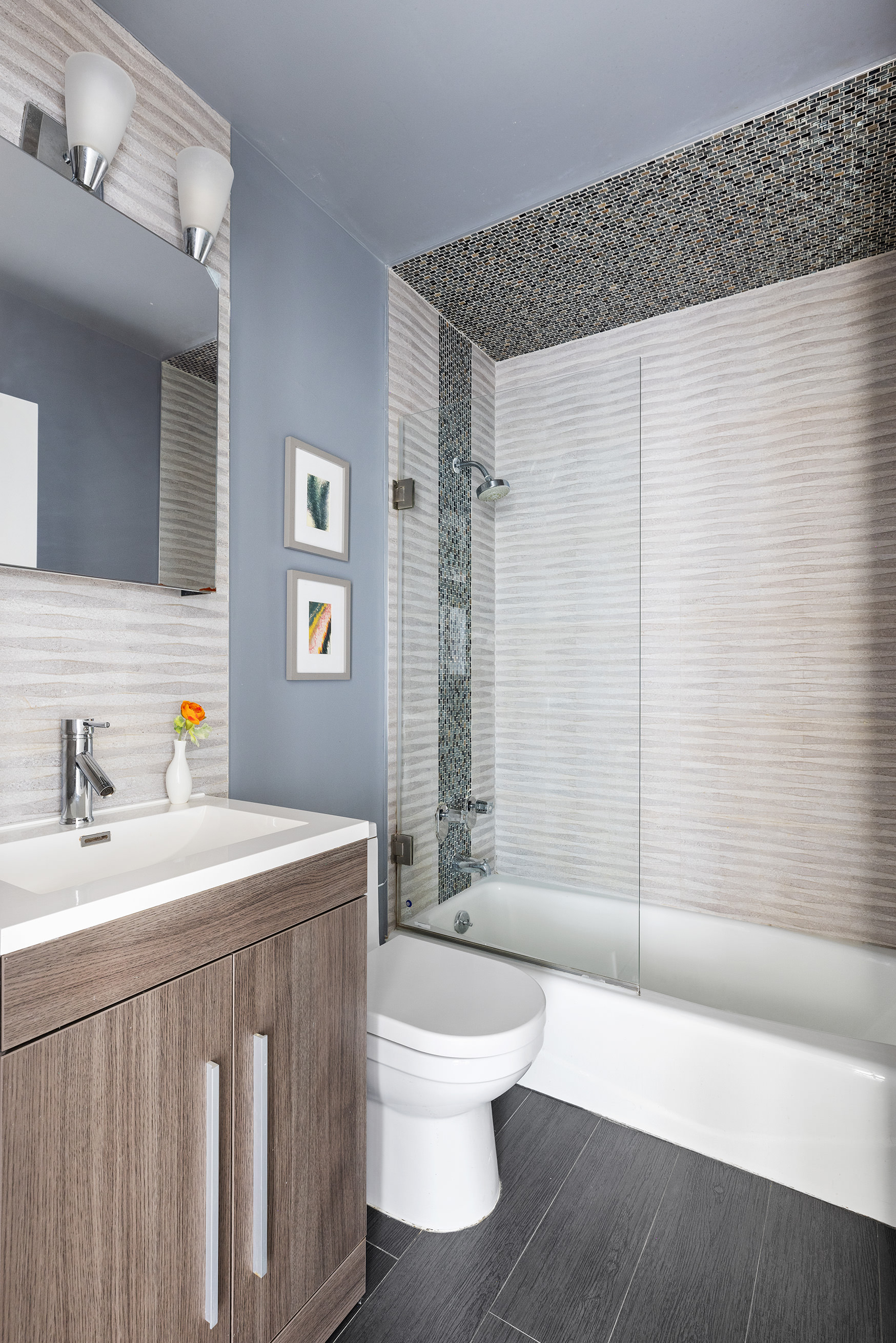 340 East 93rd Street, Unit 21F Manhattan, NY 10128 - Photo 5 of 6 a bathroom with a sink a toilet and shower