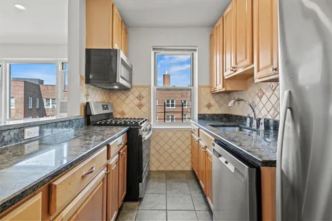 a kitchen with stainless steel appliances granite countertop a sink stove and microwave