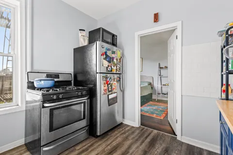 a kitchen with stainless steel appliances a stove and a refrigerator