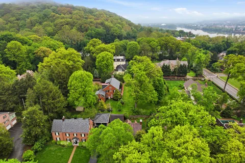 a view of a city with lush green forest
