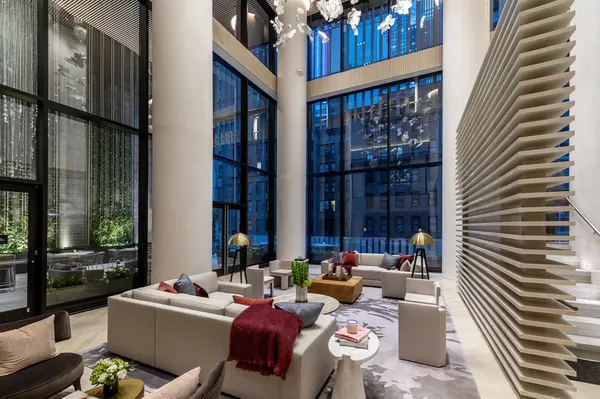 a living room with furniture and large windows