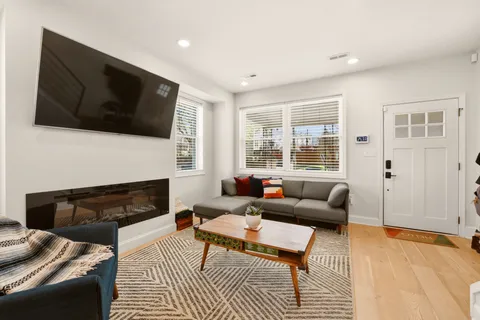a living room with furniture fireplace and flat screen tv