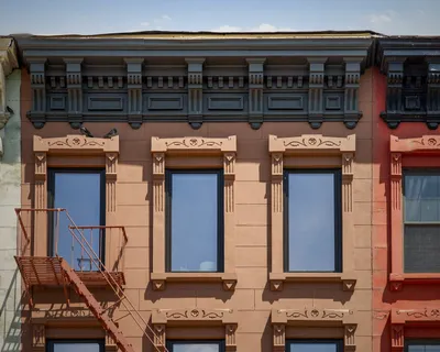 a view of a brick building with many windows