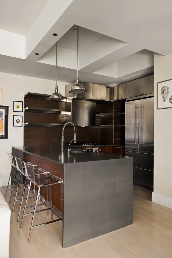 a kitchen with stainless steel appliances granite countertop a sink and a refrigerator