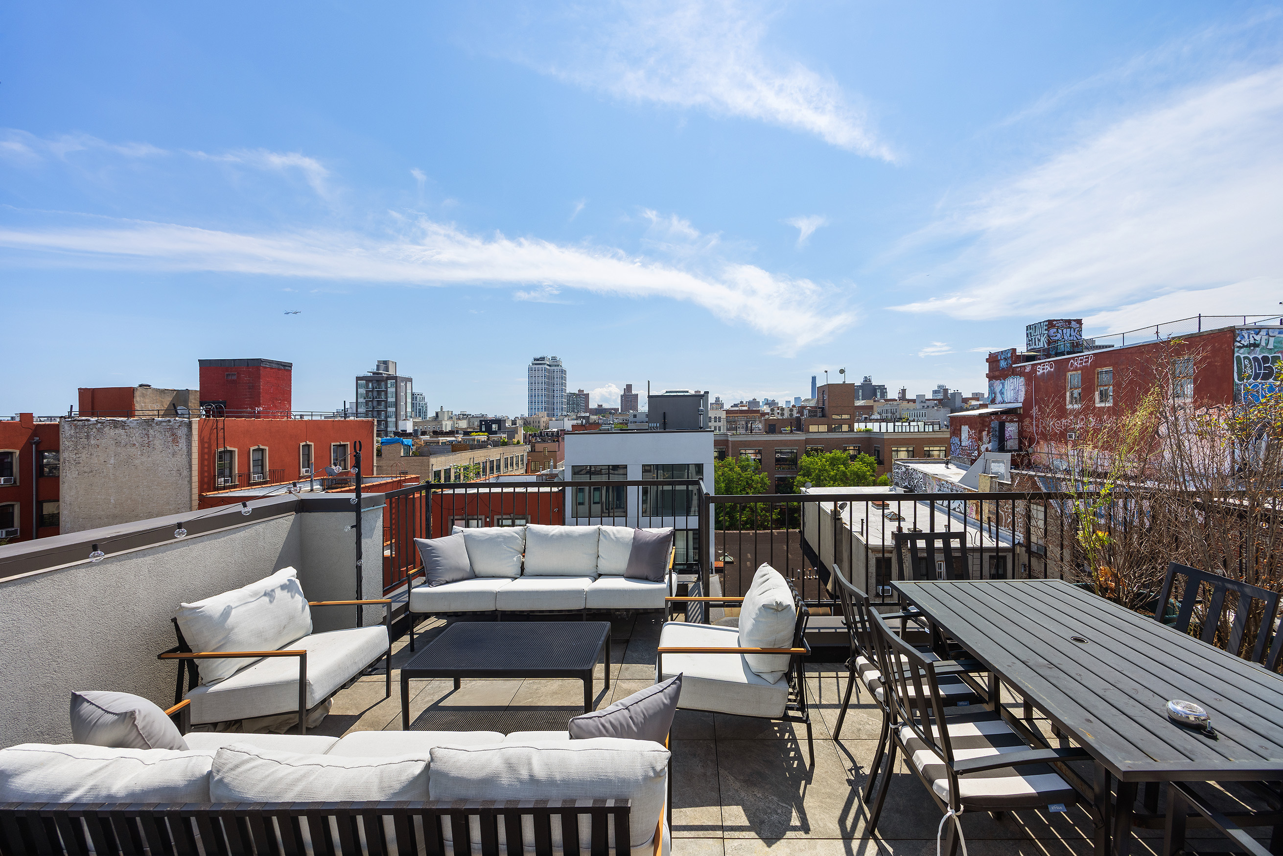 340 Metropolitan Avenue, Unit PHB Brooklyn, NY 11211 - Photo 14 of 18 a terrace with outdoor seating and city view