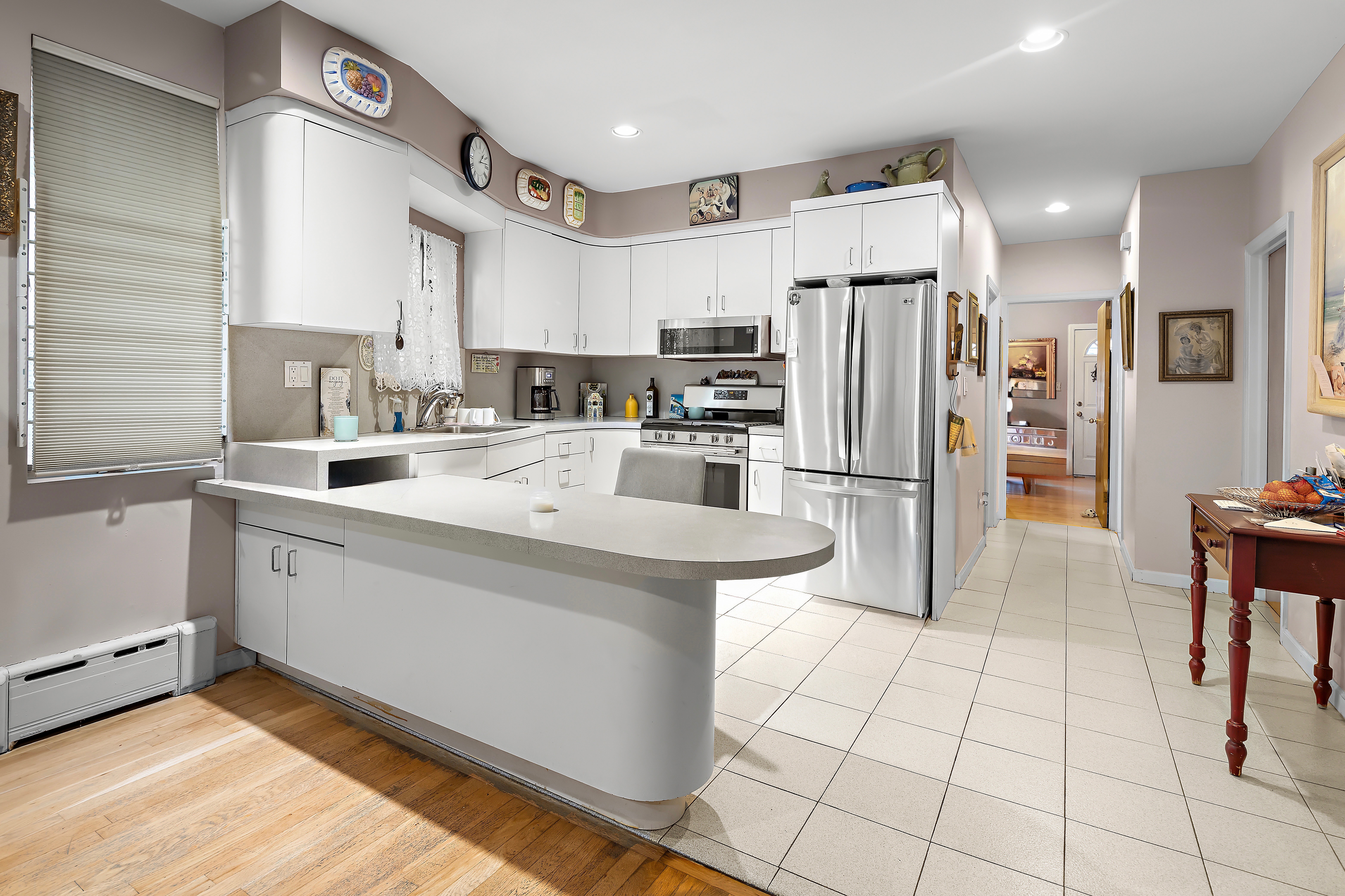 558 84th Street Brooklyn, NY 11209 - Photo 10 of 25 a kitchen with stainless steel appliances a refrigerator sink and cabinets