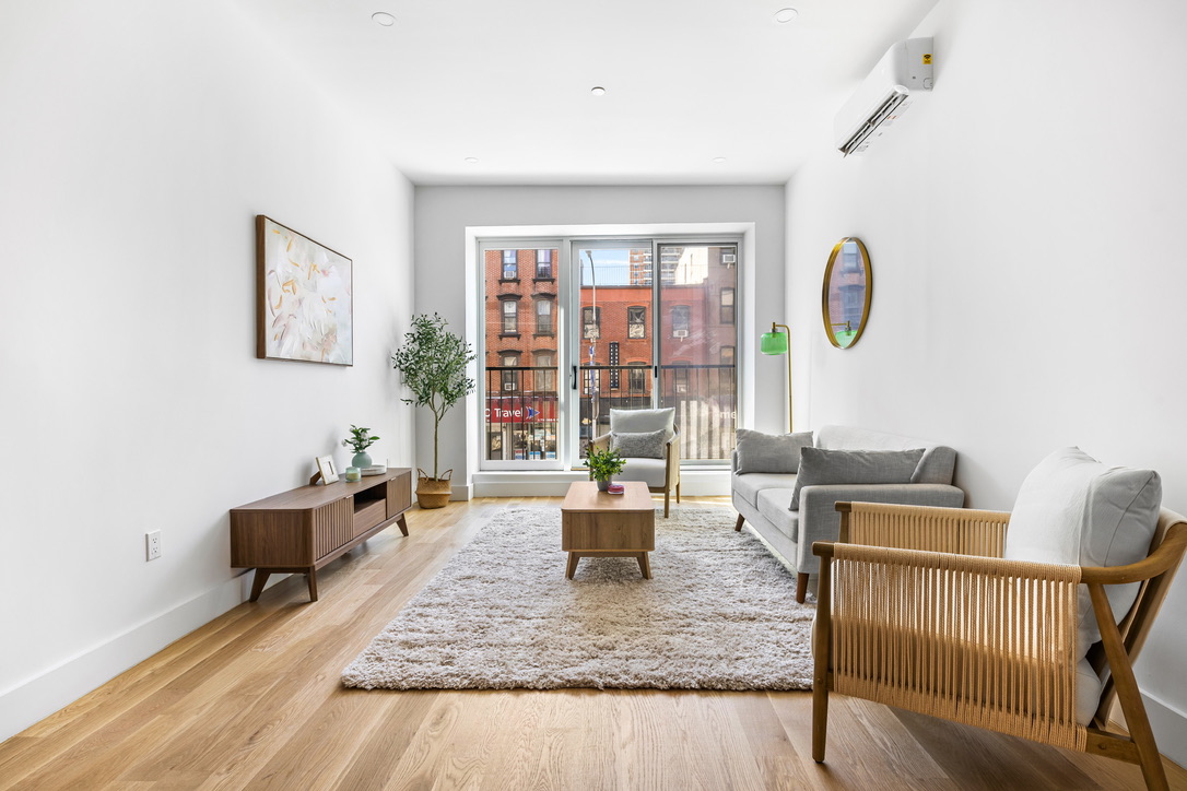 106 Graham Avenue, Unit 2A Brooklyn, NY 11206 - Photo 2 of 8 a living room with furniture and a window